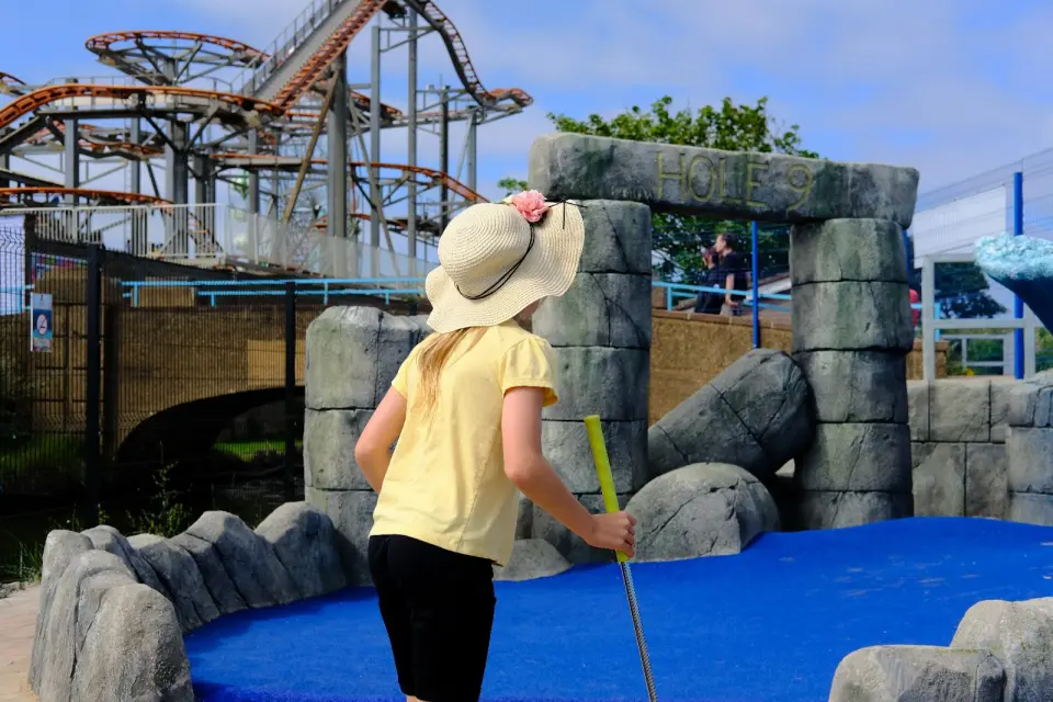 A child putting on the Atlantis Adventure Golf course