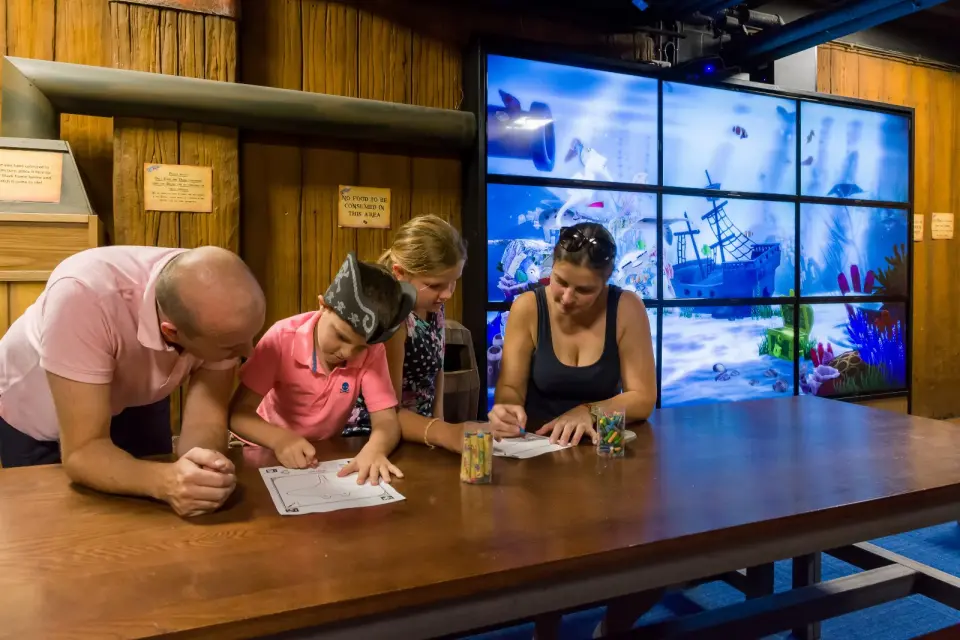 Children colouring in their own sea creatures at Doodle Cove