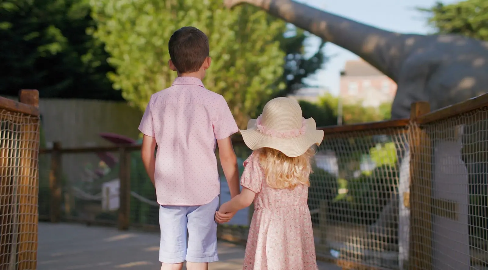 Two children on the Jurassic Falls trail looking at the dinosaurs