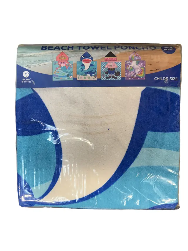 Packaged beach towel with blue and white design on a wooden surface